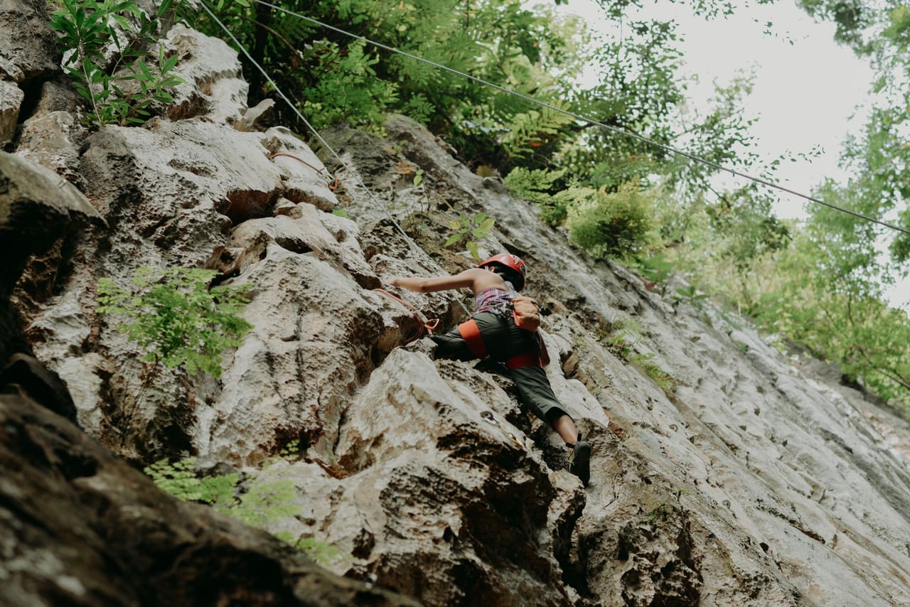 Climber ascending a limestone route at Cantabaco Crag, Toledo